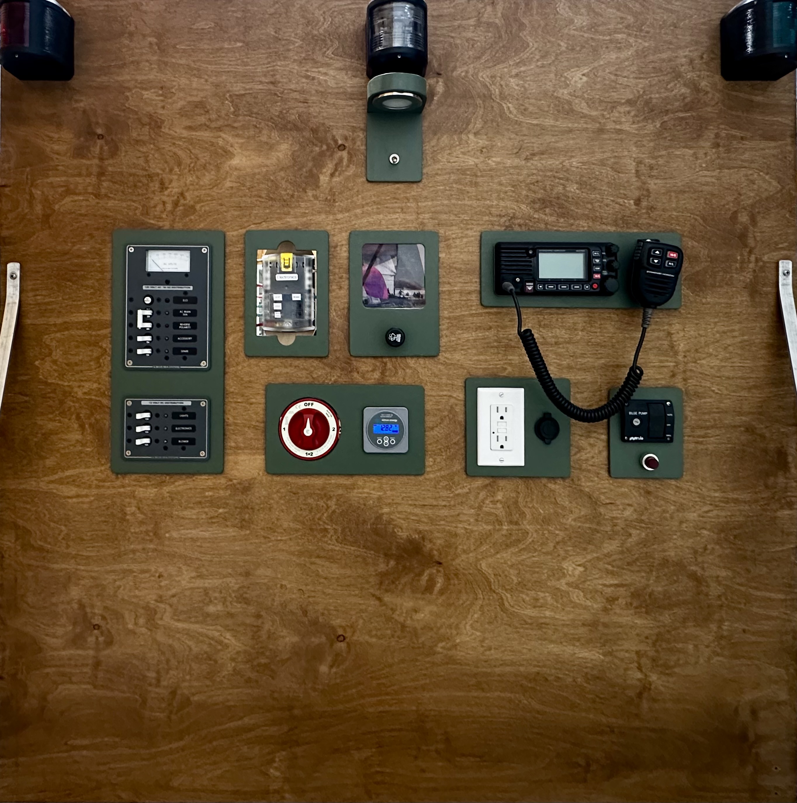 Complete AC/DC electrical systems mock-up with green faceplates, distribution panels, VHF radio, and navigation lighting