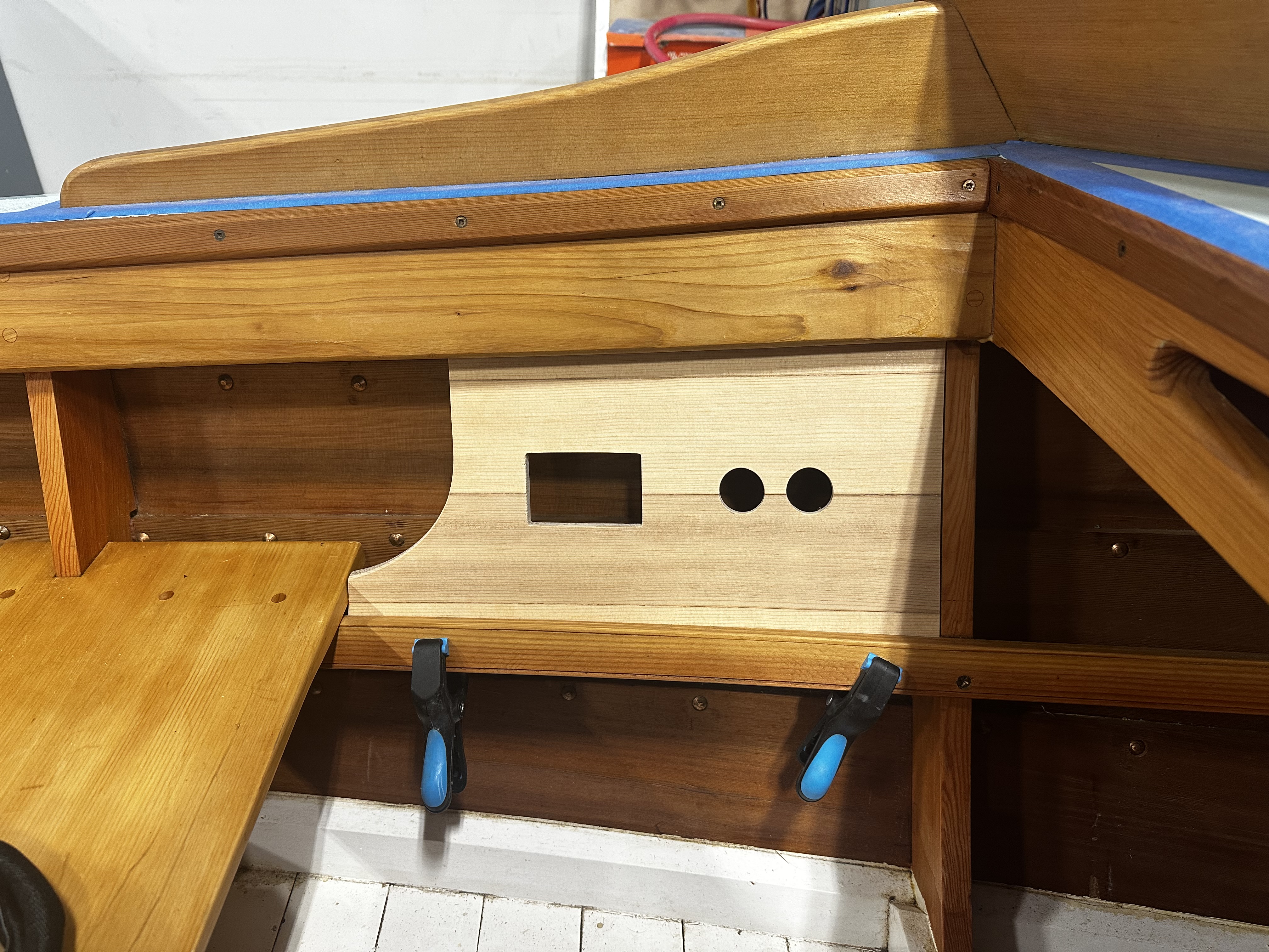 Custom marine-grade plywood console panel with cutouts for electrical controls and gauges